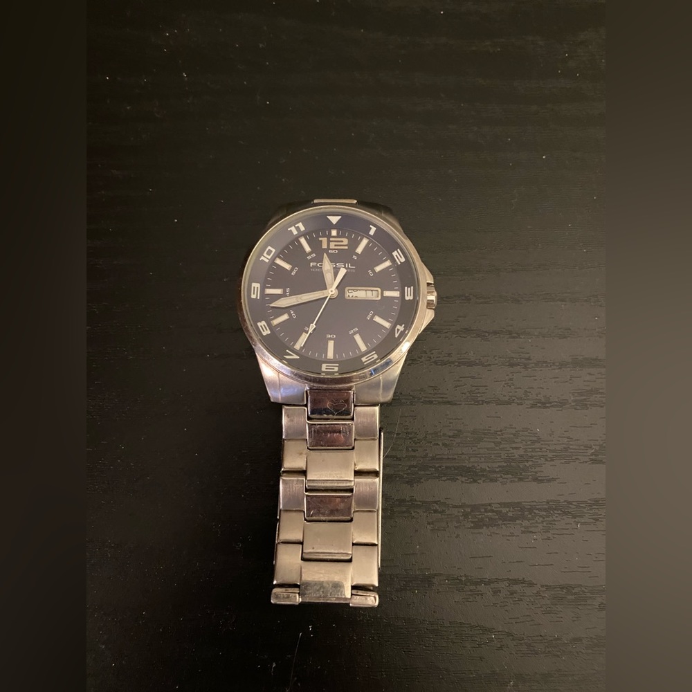 Men’s linked Fossil watch.